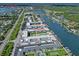 Aerial view of condo complex with boat docks near main road with text overlayed at 325 N Causeway # D-206, New Smyrna Beach, FL 32169