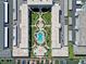 Top-down aerial view of condo complex, with pool, dock, and manicured landscaping at 325 N Causeway # D-206, New Smyrna Beach, FL 32169