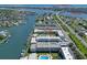 Aerial view of condos with boat docks, pool, landscaping and text overlayed at 325 N Causeway # D-206, New Smyrna Beach, FL 32169