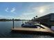 View of boat dock and boats with surrounding condos in the background at 325 N Causeway # D-206, New Smyrna Beach, FL 32169