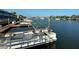 Pontoon boat docked in a canal, offering a relaxing waterfront lifestyle with easy access to boating at 325 N Causeway # D-206, New Smyrna Beach, FL 32169