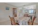 Charming dining area with seating for four, adjacent to the kitchen and living space at 325 N Causeway # D-206, New Smyrna Beach, FL 32169