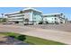Exterior view of condo buildings featuring covered parking and landscaping at 325 N Causeway # D-206, New Smyrna Beach, FL 32169