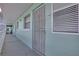 Exterior hallway with condo unit door in light teal building at 325 N Causeway # D-206, New Smyrna Beach, FL 32169