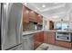 Modern kitchen with stainless steel appliances and beautiful wood cabinets at 325 N Causeway # D-206, New Smyrna Beach, FL 32169