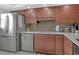 Modern kitchen with stainless steel appliances and beautiful wood cabinets at 325 N Causeway # D-206, New Smyrna Beach, FL 32169