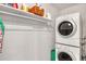 Functional laundry room with washer, dryer, and ample shelving for storage at 325 N Causeway # D-206, New Smyrna Beach, FL 32169