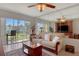 Comfortable living room with sofa, large mirror wall, ceiling fan, and outdoor views at 325 N Causeway # D-206, New Smyrna Beach, FL 32169