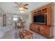 Living room with sofa, dining set, large TV and console and view to the kitchen at 325 N Causeway # D-206, New Smyrna Beach, FL 32169