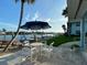 Outdoor seating area with table and chairs, overlooking the water and boat docks, ideal for entertaining at 325 N Causeway # D-206, New Smyrna Beach, FL 32169
