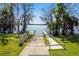 Community boat dock leading to a lake, surrounded by trees, shrubbery and green grass at 329 Kantor Blvd, Casselberry, FL 32707