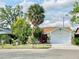 Charming single-story home featuring a well-manicured lawn, mature trees, and a two-car garage at 329 Kantor Blvd, Casselberry, FL 32707