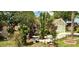 Beautifully landscaped front yard with a stone exterior and lush, mature trees and greenery at 329 Kantor Blvd, Casselberry, FL 32707