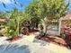 Beautifully landscaped front yard with a stone exterior and lush, mature trees and greenery at 329 Kantor Blvd, Casselberry, FL 32707