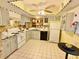 Well-maintained vintage kitchen with white cabinets, tile floors, and a black dishwasher at 329 Kantor Blvd, Casselberry, FL 32707