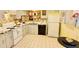 Well-maintained vintage kitchen with white cabinets, tile floors, and a black dishwasher at 329 Kantor Blvd, Casselberry, FL 32707