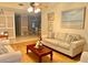 Cozy living room featuring hardwood floors, comfortable seating, and a view to the dining area at 329 Kantor Blvd, Casselberry, FL 32707