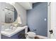 Stylish bathroom featuring modern vanity, round mirror, and a tiled shower at 3425 N Westmoreland Dr, Orlando, FL 32804