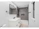 Bathroom featuring gray tiling in the tub and shower area, white vanity, and modern fixtures at 3425 N Westmoreland Dr, Orlando, FL 32804