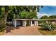 Charming single-story home with a brick driveway and a vibrant green front door at 3425 N Westmoreland Dr, Orlando, FL 32804