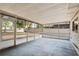 Enclosed patio with concrete flooring, screen windows, and a view of the backyard at 3425 N Westmoreland Dr, Orlando, FL 32804