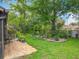 Well-manicured backyard with lush lawn, mature trees, and a brick patio area for outdoor enjoyment at 419 Newton Pl, Longwood, FL 32779