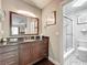 Elegant bathroom featuring a dark wood vanity and a walk-in glass shower at 419 Newton Pl, Longwood, FL 32779
