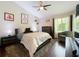Comfortable bedroom featuring hardwood floors, ceiling fan, and a large window at 419 Newton Pl, Longwood, FL 32779