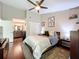 Spacious bedroom with hardwood floors, ceiling fan, and a connected bathroom at 419 Newton Pl, Longwood, FL 32779