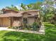 Charming home features a well-manicured lawn, garden and inviting walkway, creating a welcoming curb appeal at 419 Newton Pl, Longwood, FL 32779