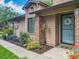 Cozy home exterior with brick accents, tidy landscaping, and a welcoming front entrance at 419 Newton Pl, Longwood, FL 32779