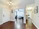 Inviting foyer featuring hardwood floors, an elegant chandelier, and access to multiple rooms at 419 Newton Pl, Longwood, FL 32779