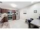 Bright kitchen equipped with stainless steel appliances, stylish backsplash, and sleek dark cabinetry at 419 Newton Pl, Longwood, FL 32779