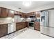 Stylish kitchen with stainless steel appliances, mosaic tile backsplash and beautiful brown cabinets at 419 Newton Pl, Longwood, FL 32779