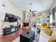 Inviting living room with fireplace, slider, vaulted ceilings, and stylish furnishings at 419 Newton Pl, Longwood, FL 32779