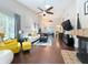 Bright living room featuring vaulted ceilings, fireplace, stylish furnishings, and easy access to dining and kitchen at 419 Newton Pl, Longwood, FL 32779