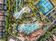 Aerial view of the community's luxurious pools, lazy river, and tennis courts amid lush landscaping at 4200 Oaktree Dr, Davenport, FL 33837