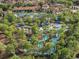 Aerial view showcasing a stunning community pool, winding lazy river, and lush landscaping at 4200 Oaktree Dr, Davenport, FL 33837