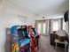 A fully equipped game room with vintage arcade machines and a cozy lounge area, perfect for entertainment at 4200 Oaktree Dr, Davenport, FL 33837