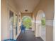 Cozy balcony with tan columns, two chairs, wooden floor, and an open view at 4200 Oaktree Dr, Davenport, FL 33837