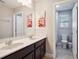 Double sink bathroom with dark cabinets, neutral walls and Frozen themed decor at 4200 Oaktree Dr, Davenport, FL 33837