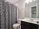 Bathroom featuring single sink vanity, and shower/tub combo with patterned shower curtain at 4200 Oaktree Dr, Davenport, FL 33837