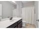 Bathroom features a single sink vanity with tile flooring, updated fixtures, and a shower tub combo at 4200 Oaktree Dr, Davenport, FL 33837