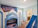 Playful bedroom with unique castle bunk, Frozen themed mural, and connecting bath at 4200 Oaktree Dr, Davenport, FL 33837