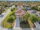 Charming two-story home with a tile roof, balcony, palm trees, and a well-maintained front yard at 4200 Oaktree Dr, Davenport, FL 33837
