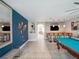 An entertainment room boasts a pool table, custom bar, accent wall, and stylish lighting creating a fun, relaxing atmosphere at 4200 Oaktree Dr, Davenport, FL 33837