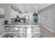 Bright kitchen features white cabinets, granite countertops, stainless appliances, and an eat-in island with barstool seating at 4200 Oaktree Dr, Davenport, FL 33837