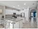 Bright kitchen features white cabinets, granite countertops, stainless appliances, and an eat-in island with barstool seating at 4200 Oaktree Dr, Davenport, FL 33837