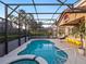 Screened pool area with spa, ample seating, poolside dining area, and Jurassic Park themed patio at 4200 Oaktree Dr, Davenport, FL 33837