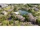 Expansive community featuring lush landscaping, a scenic lake, and multiple residential buildings at 4708 Walden Cir # 37, Orlando, FL 32811